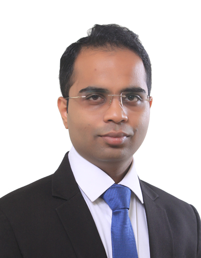 Siddharth Dalmia wearing a dark suit and blue tie